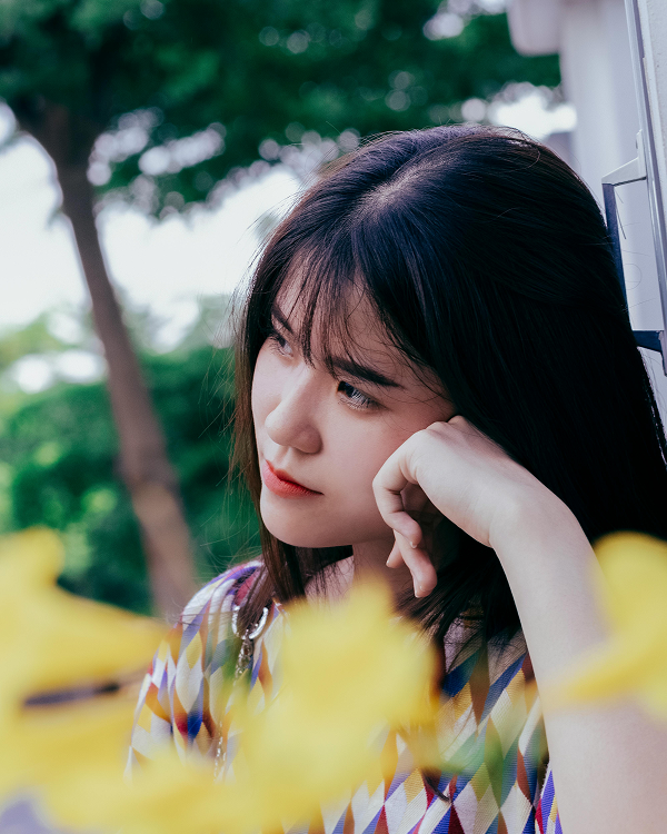 Women in thought resting head on hand