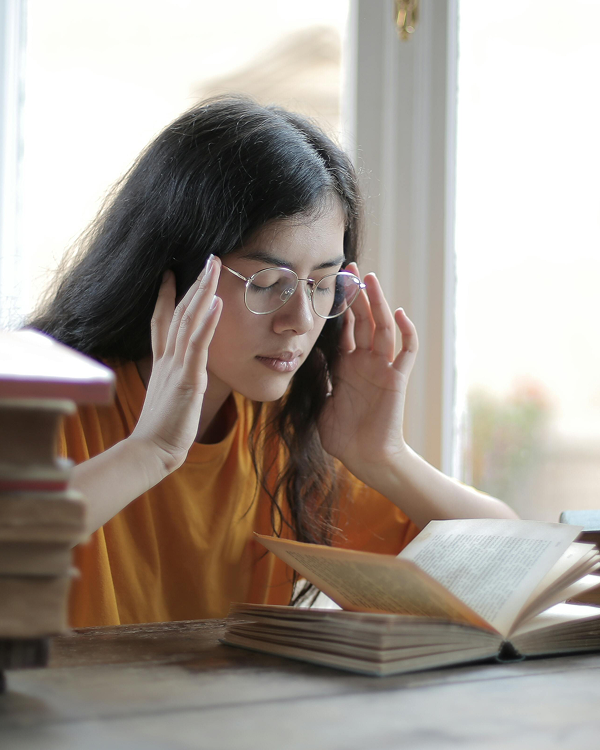 person struggling to concentrate on a book